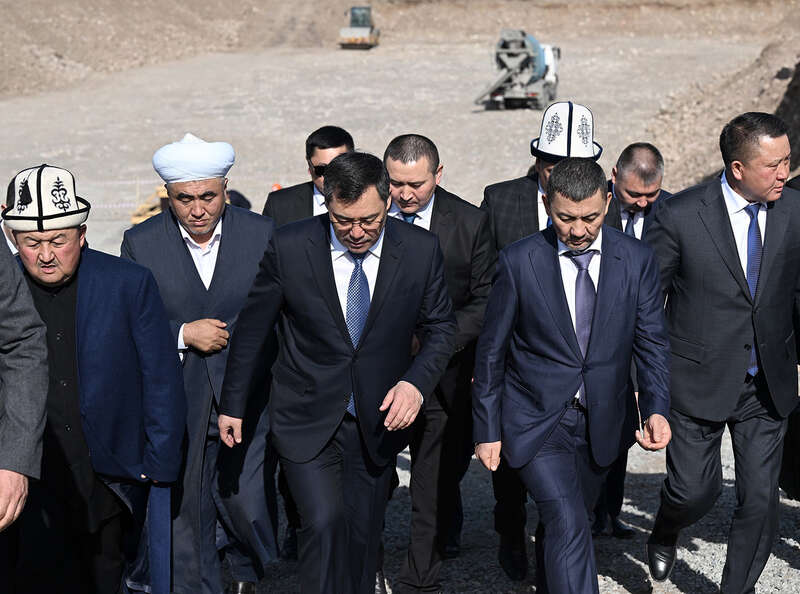 Kyrgyzstan&rsquo;s President Sadyr Japarov walks with Khabibula Abdukadyr